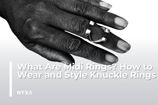 Close-up of a hand wearing a silver midi ring, minimalist style, knuckle ring fashion guide, polished modern jewelry.