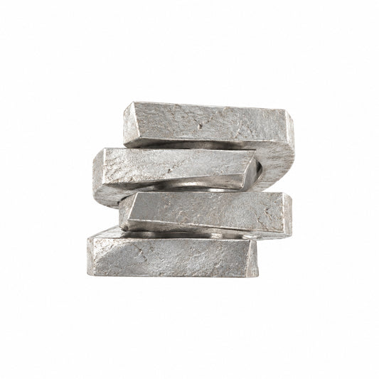 NYXA Apollo sterling silver ring showing overlapping angular bands with a rough, pitted surface.