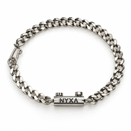 Overhead view of the Tekton sterling silver curb chain bracelet with a hook clasp and NYXA centerpiece topped by two bolts.